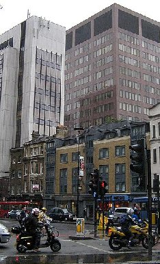 Traffic on a wet, gray day on Wormwood Street in London.